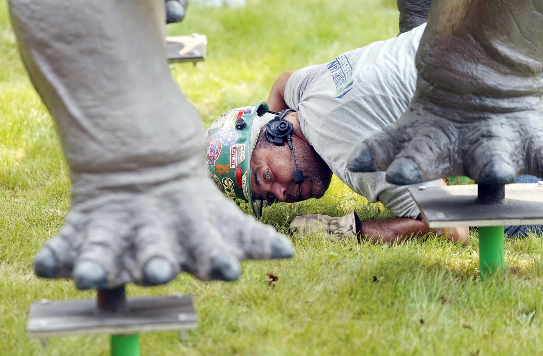 Man checking statue's feet
